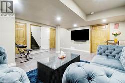 Living area with stairway, recessed lighting, and wood finished floors -