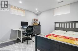 Bedroom featuring multiple windows, an office area, and recessed lighting -