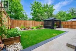 Fenced backyard featuring a gazebo and a patio -