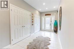 Entrance foyer featuring light tile patterned floors and recessed lighting -