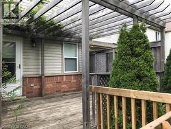 View of home's exterior featuring a wooden deck and a pergola -
