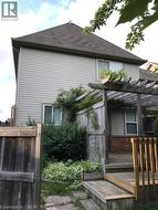 View of home's exterior with a deck and roof with shingles -