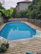 View of swimming pool featuring a deck and a fenced backyard -