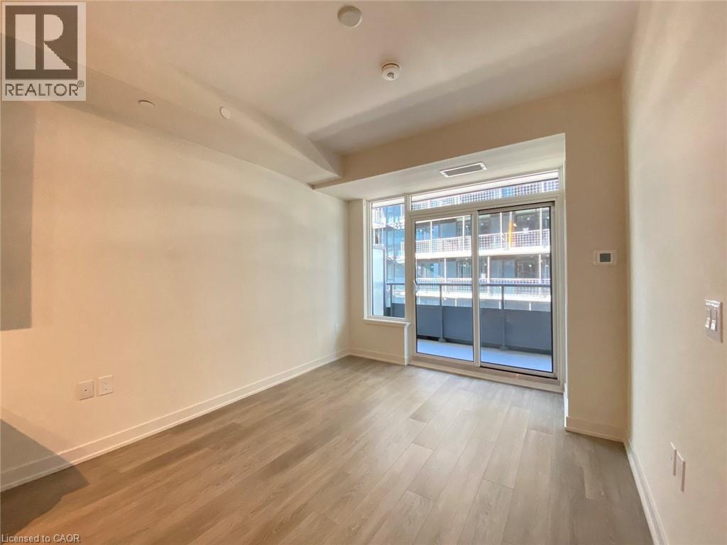 Unfurnished room featuring light wood-style floors and baseboards - 212 King William Street Unit# 1010, Hamilton, ON - Indoor Photo Showing Other Room
