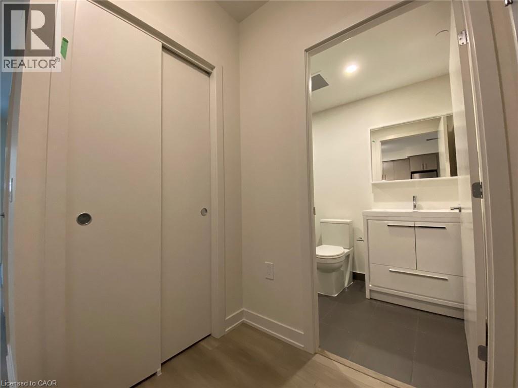 Half bath featuring vanity, dark wood finished floors, and recessed lighting - 212 King William Street Unit# 1010, Hamilton, ON - Indoor Photo Showing Bathroom