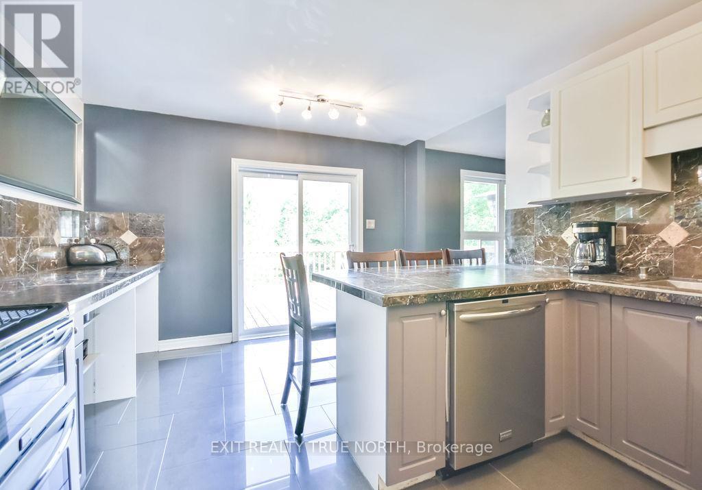 Seamless walkout to the deck - 28 Nicholson Crescent, Springwater, ON - Indoor Photo Showing Kitchen