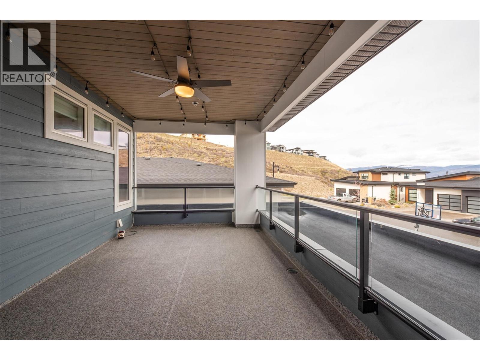 Front Patio with Remote Retractable Sunscreens for privacy, allowing you to expand your living area into the outdoors - 1235 Ponds Avenue, Kelowna, BC - Outdoor With Exterior