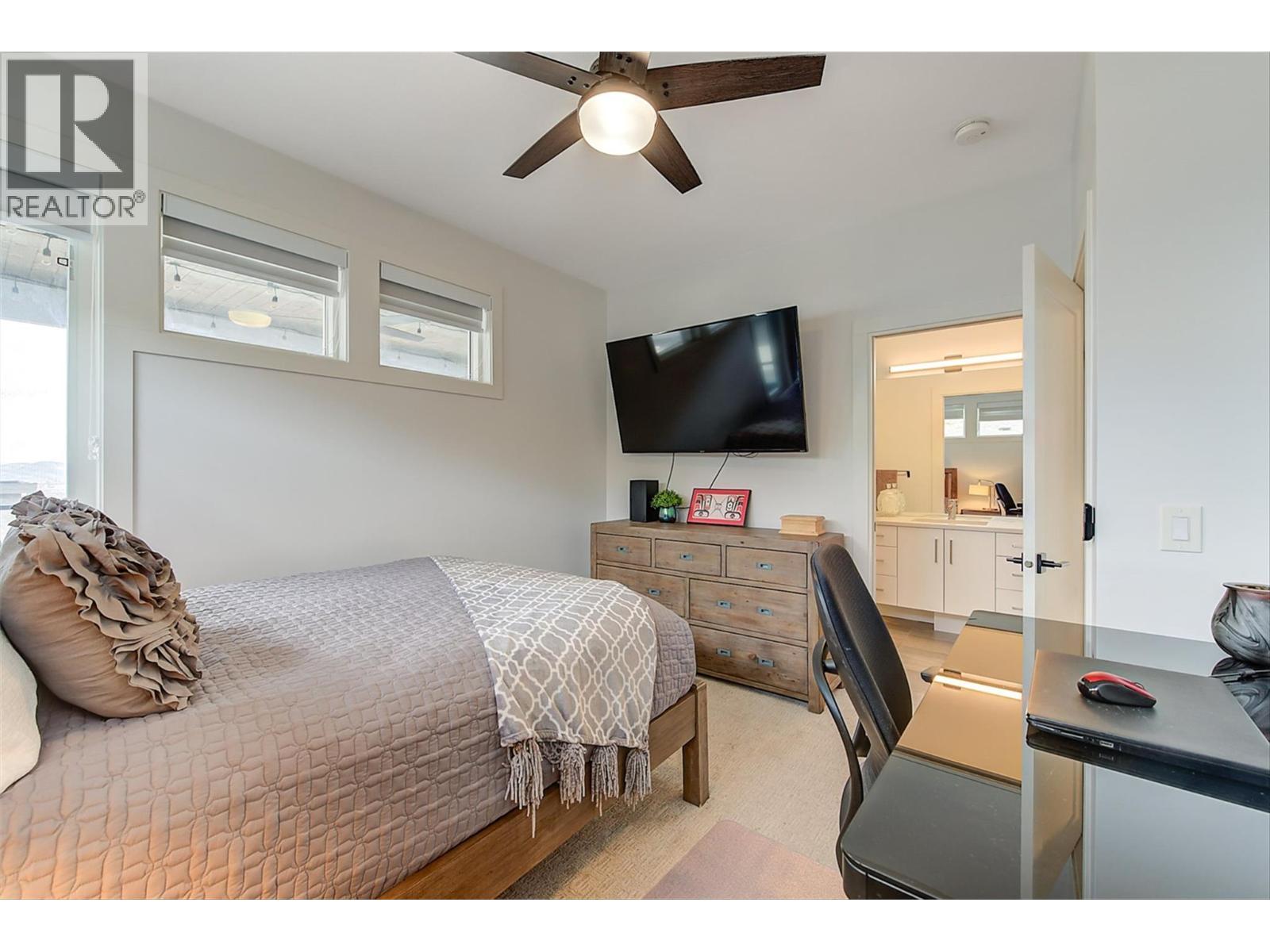 Bedroom #2 w/ Ensuite access to the main floor bath - 1235 Ponds Avenue, Kelowna, BC - Indoor Photo Showing Bedroom