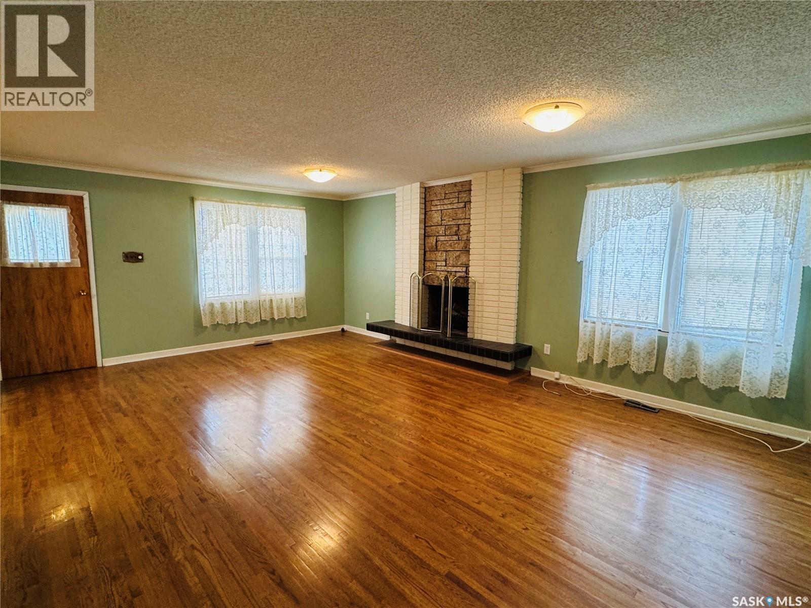 121 2Nd Avenue W, Biggar, SK - Indoor Photo Showing Living Room With Fireplace