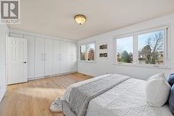 The Spacious Primary Bedroom Offers Custom Closets -