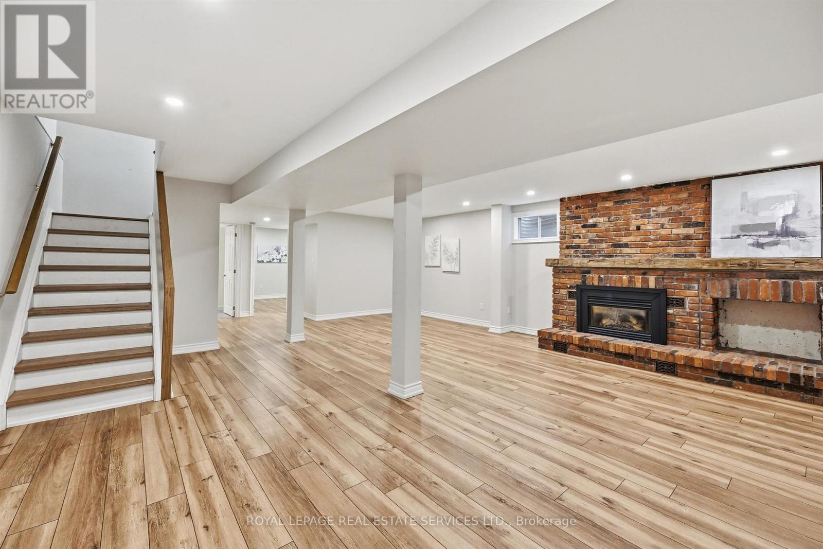 Large Recreation Room with a Brick Gas Fireplace - 426 Parkridge Crescent, Oakville, ON - Indoor Photo Showing Other Room With Fireplace