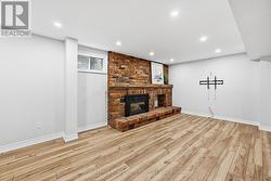 Large Recreation Room with a Brick Gas Fireplace -