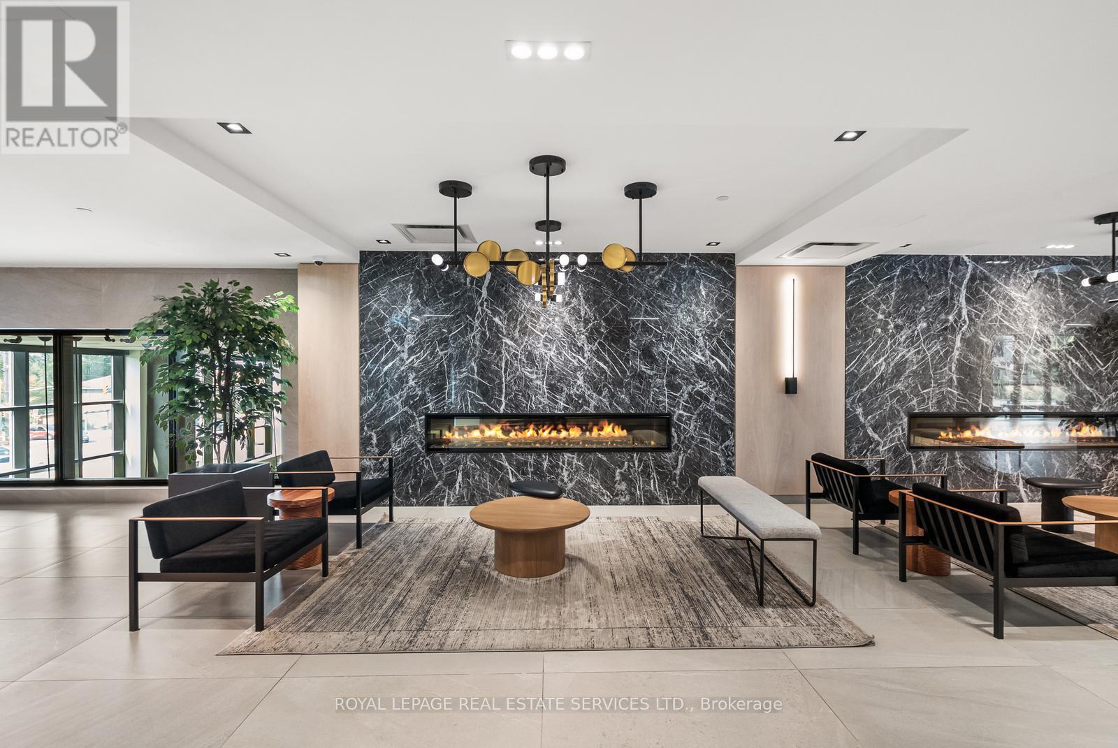 Seating Areas In Lobby - 812 - 50 George Butchart Drive, Toronto, ON - Indoor With Fireplace