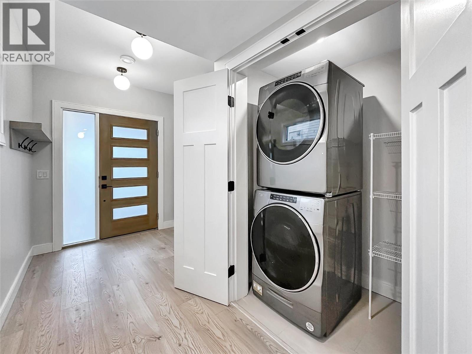Laundry with Storage - 1839 Grey Owl Court, Kelowna, BC - Indoor Photo Showing Laundry Room