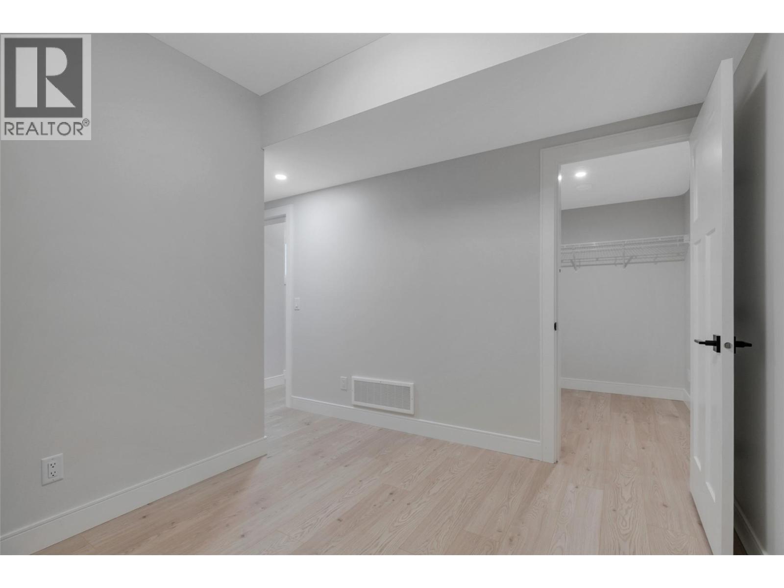 Entry level bedroom with big Walk-in closet - 1839 Grey Owl Court, Kelowna, BC - Indoor Photo Showing Other Room