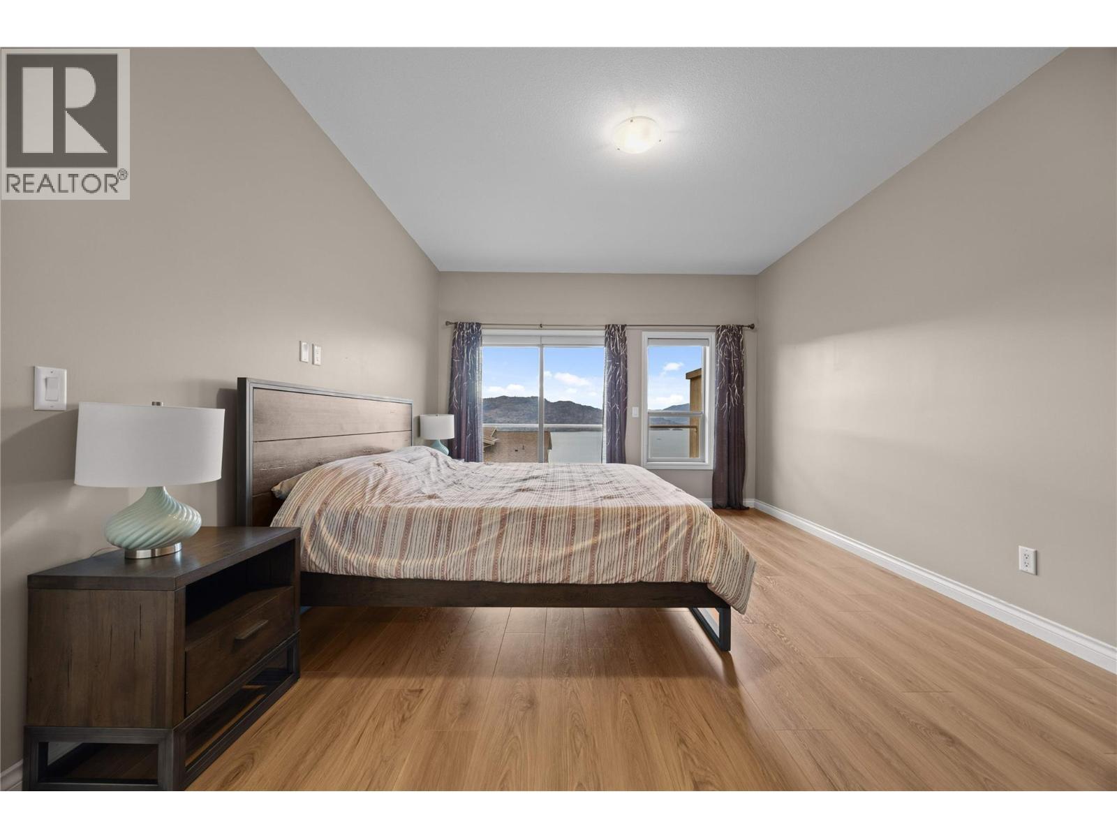 Primary suite offering direct access to its own deck - 5165 Trepanier Bench Road Unit# 250, Peachland, BC - Indoor Photo Showing Bedroom