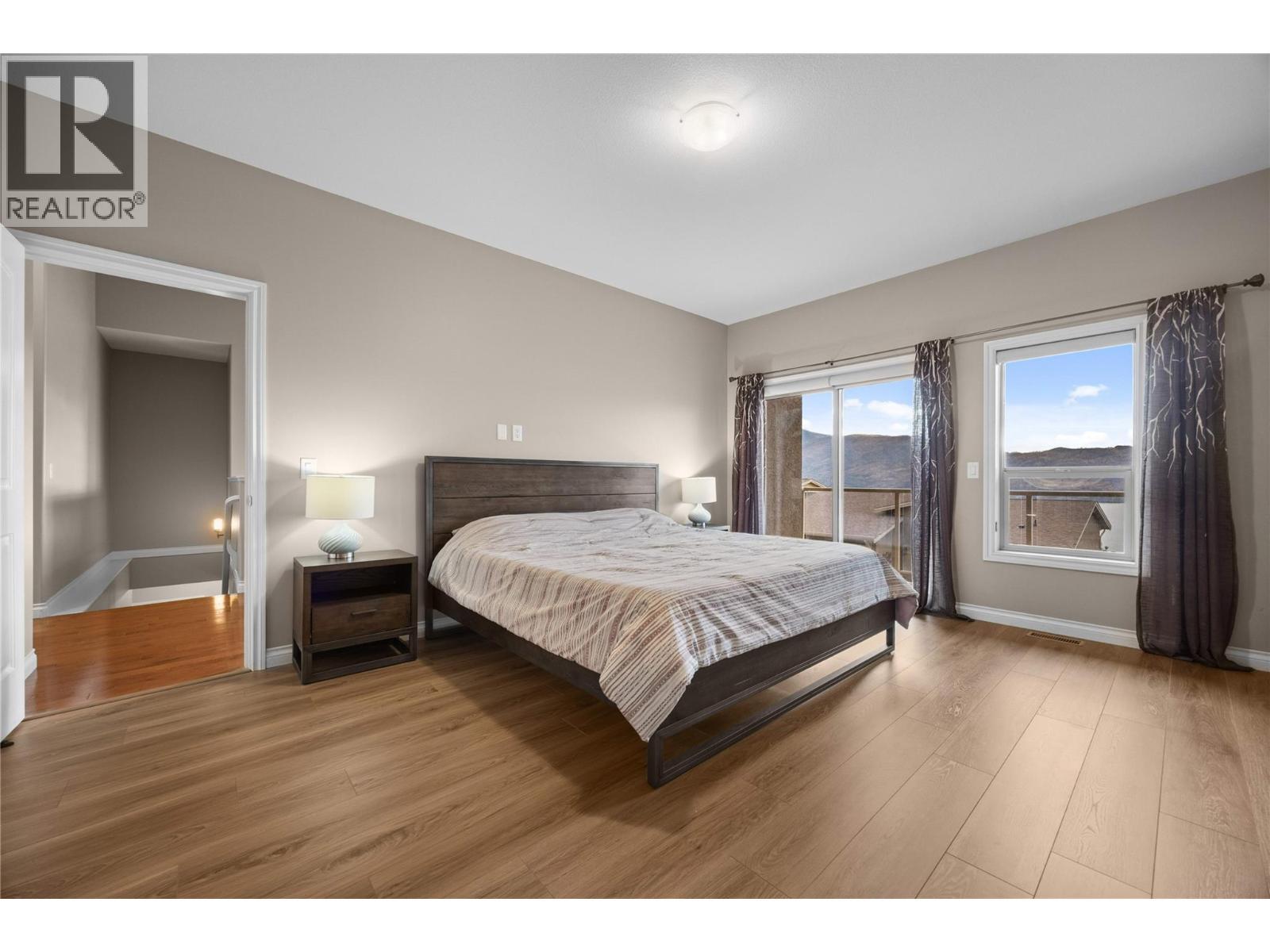 Primary suite offering direct access to its own deck - 5165 Trepanier Bench Road Unit# 250, Peachland, BC - Indoor Photo Showing Bedroom