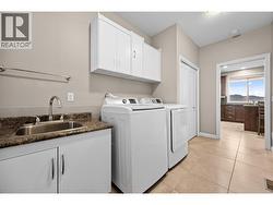 Laundry room with cabinets and sink -