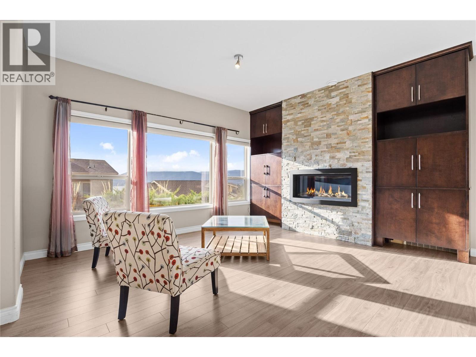 Family room with gas fireplace and built in cabinetry - 5165 Trepanier Bench Road Unit# 250, Peachland, BC - Indoor With Fireplace
