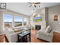 Living room with gas fireplace, vaulted ceilings, large windows to showcase the lake and mountain views -