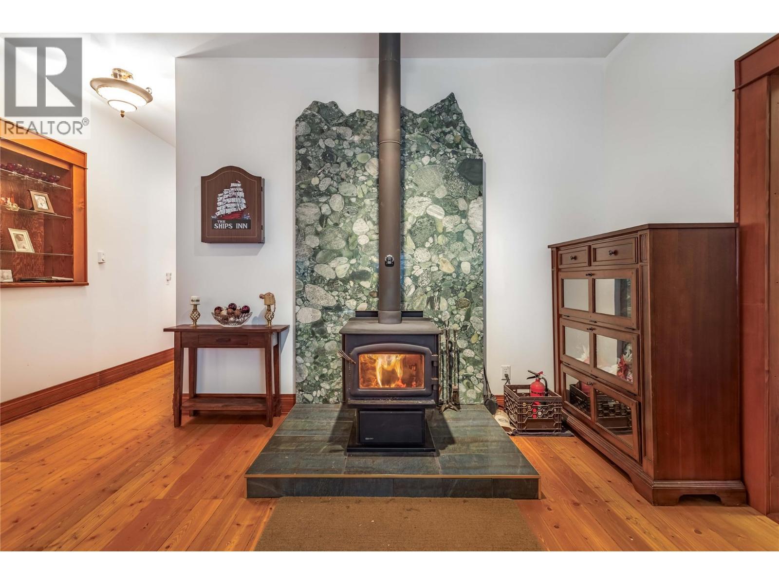 60 Pringle Road, Carmi, BC - Indoor Photo Showing Other Room With Fireplace