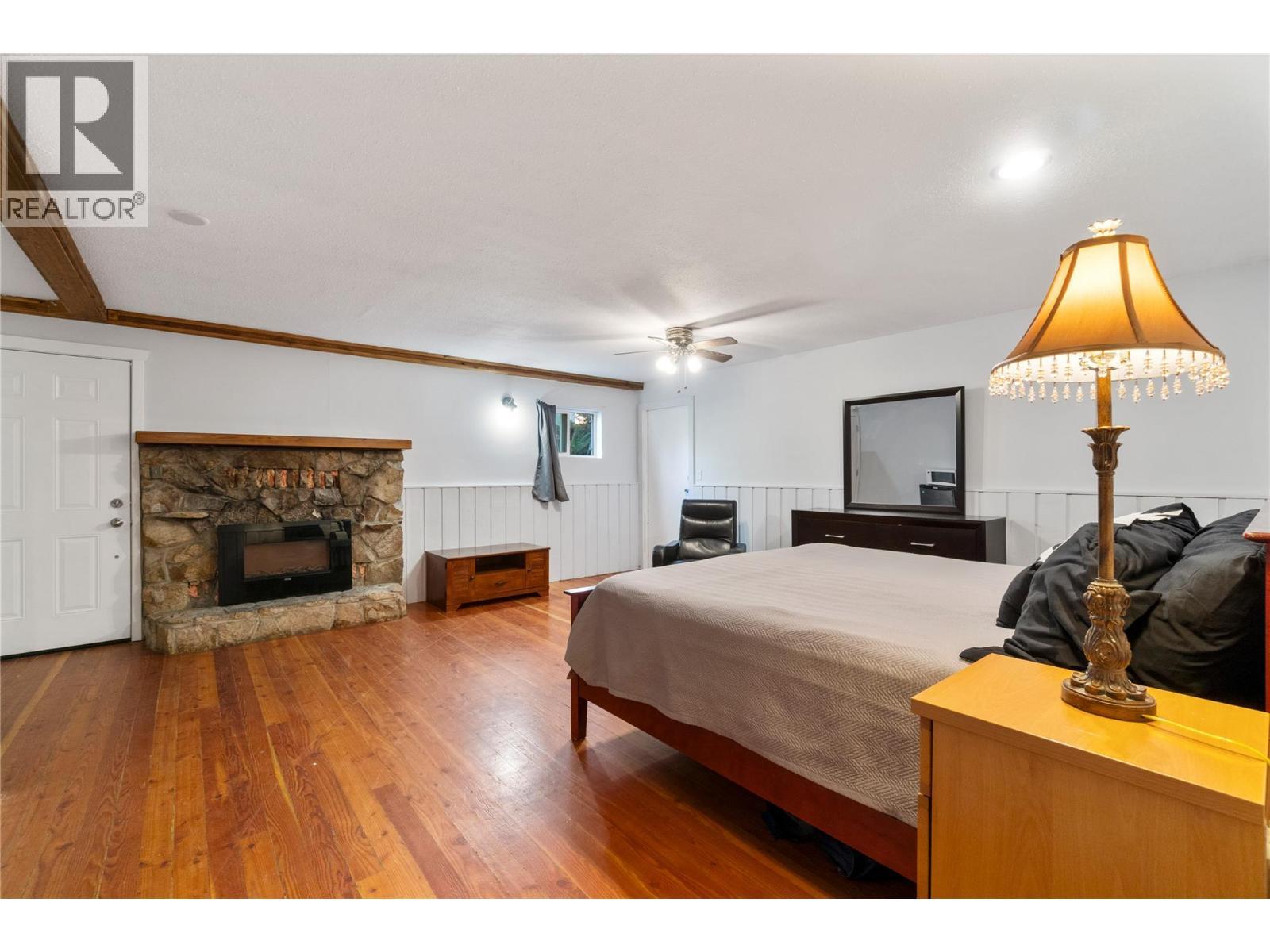 5327 Squilax Anglemont Road, Celista, BC - Indoor Photo Showing Bedroom With Fireplace