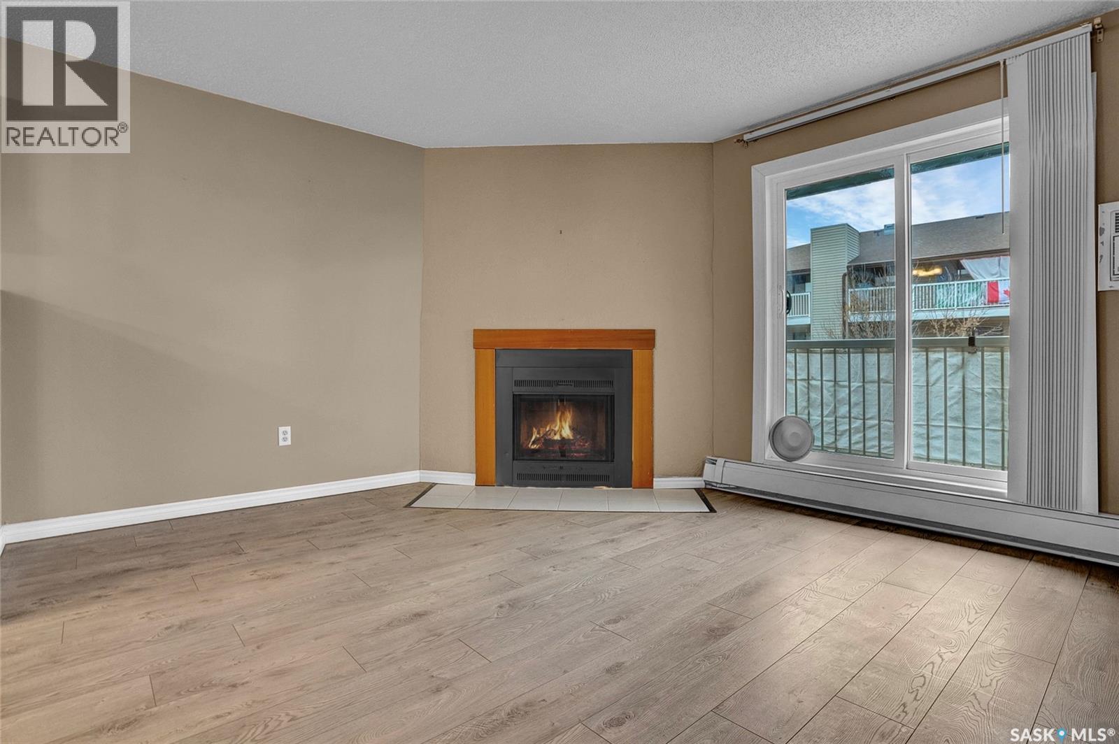 205 51 Wood Lily Drive, Moose Jaw, SK - Indoor Photo Showing Living Room With Fireplace