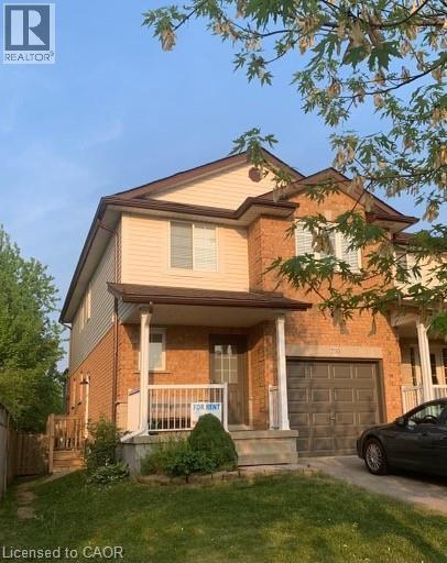 View of front of property featuring covered porch, brick siding, a garage, and driveway - 750 Paris Boulevard Unit# 1, Waterloo, ON - Outdoor