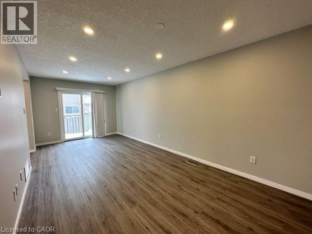 Spare room with recessed lighting, a textured ceiling, and dark wood-style flooring - 750 Paris Boulevard Unit# 1, Waterloo, ON - Indoor Photo Showing Other Room
