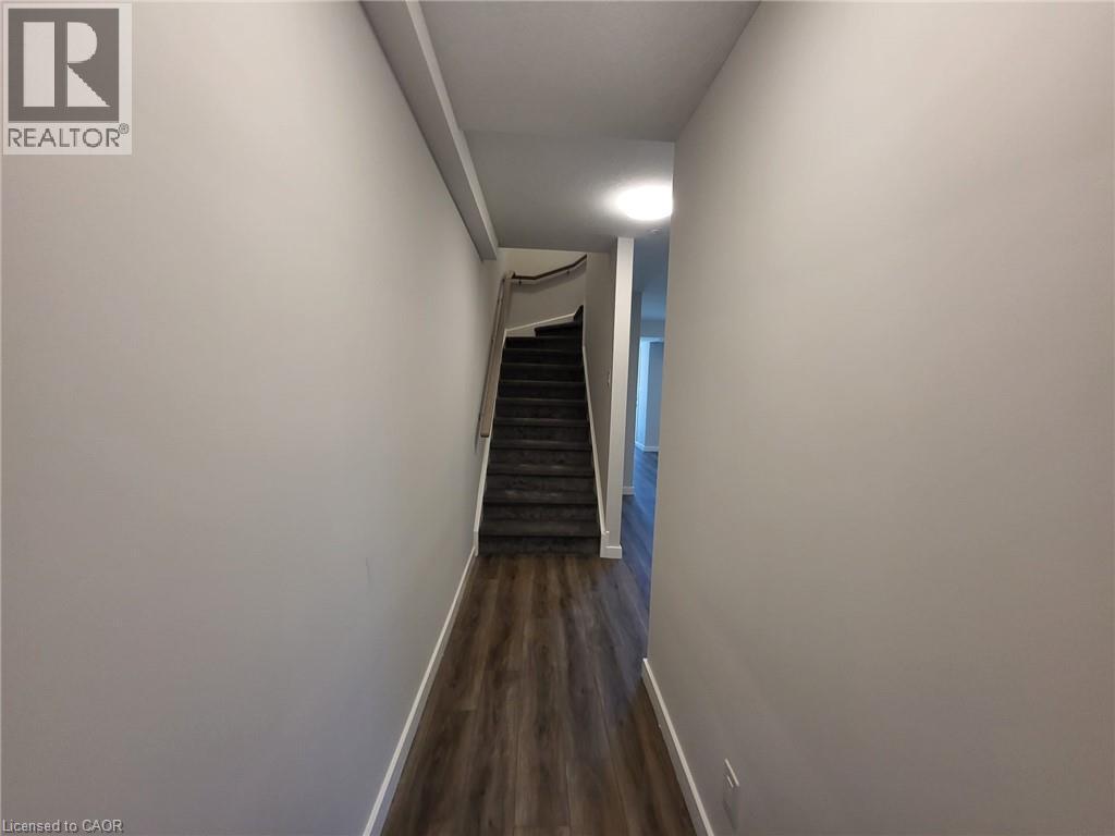 Hall with dark wood-style flooring and stairs - 118 Gravel Ridge Trail Unit# D16, Kitchener, ON - Indoor Photo Showing Other Room