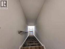 Stairs featuring baseboards and wood finished floors -