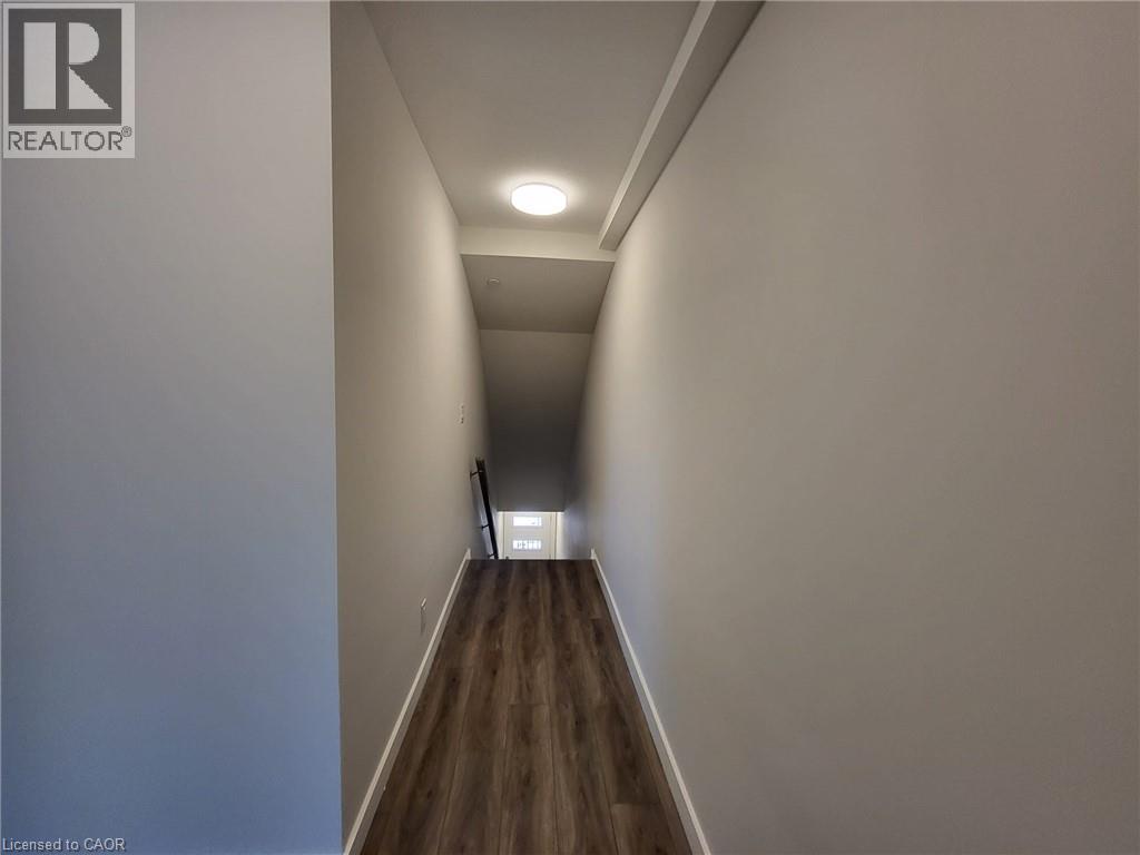Hallway with baseboards and dark wood-style floors - 118 Gravel Ridge Trail Unit# D16, Kitchener, ON - Indoor Photo Showing Other Room
