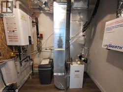 Utilities featuring heating unit and tankless water heater -
