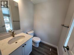 Bathroom featuring vanity and dark wood-style flooring -
