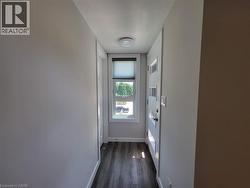 Doorway to outside with baseboards and wood finished floors -
