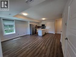 Kitchen with open floor plan, white cabinets, light countertops, and a kitchen island -