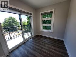 Unfurnished room with baseboards and dark wood finished floors -