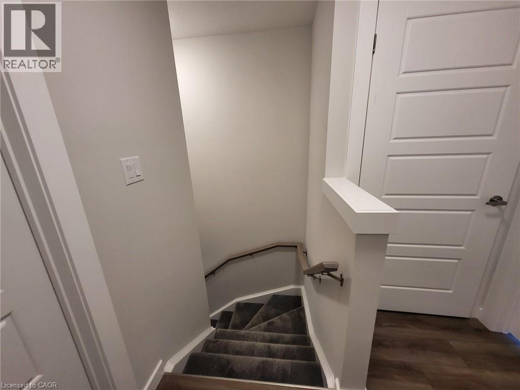 Staircase featuring wood finished floors and baseboards - 118 Gravel Ridge Trail Unit# D16, Kitchener, ON - Indoor Photo Showing Other Room