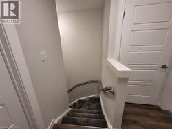 Staircase featuring wood finished floors and baseboards -
