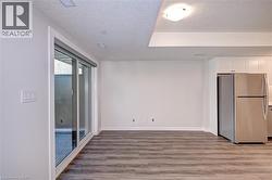 Spare room with light wood-style flooring and a textured ceiling -