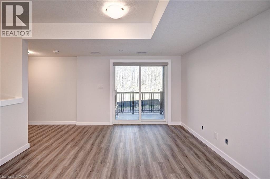 Empty room featuring wood finished floors and a textured ceiling - 118 Gravel Ridge Trail Unit# C17, Kitchener, ON - Indoor Photo Showing Other Room