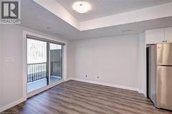 Empty room featuring light wood-type flooring and a textured ceiling -