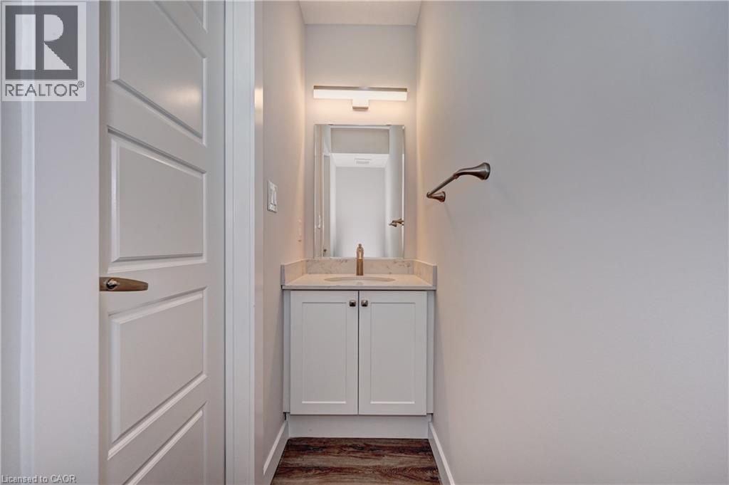 Half bathroom with vanity and dark wood-style flooring - 118 Gravel Ridge Trail Unit# C17, Kitchener, ON - Indoor
