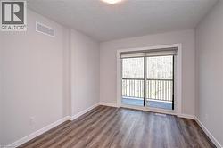 Empty room featuring wood finished floors and a textured ceiling -
