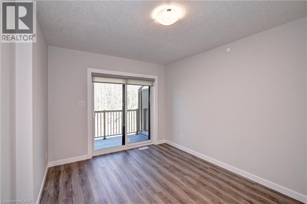Spare room featuring wood finished floors and a textured ceiling - 118 Gravel Ridge Trail Unit# C17, Kitchener, ON - Indoor Photo Showing Other Room