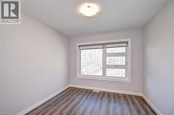 Empty room featuring baseboards and wood finished floors -