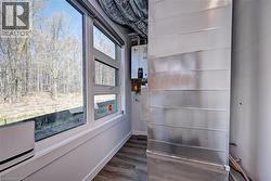 Detailed view of wood finished floors and water heater -