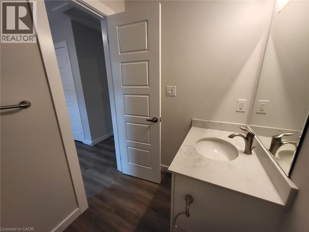 Bathroom with vanity and dark wood-style flooring - 118 Gravel Ridge Trail Unit# B23, Kitchener, ON - Indoor Photo Showing Bathroom