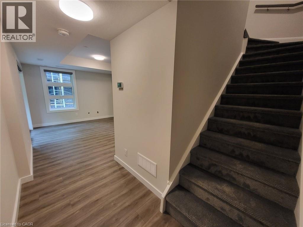 Stairway featuring baseboards and wood finished floors - 118 Gravel Ridge Trail Unit# B23, Kitchener, ON - Indoor Photo Showing Other Room