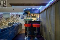 Indoor dry bar with dark wood-style flooring -